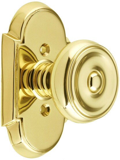 Arched Rosette Set With Waverly Knobs in Polished Brass.